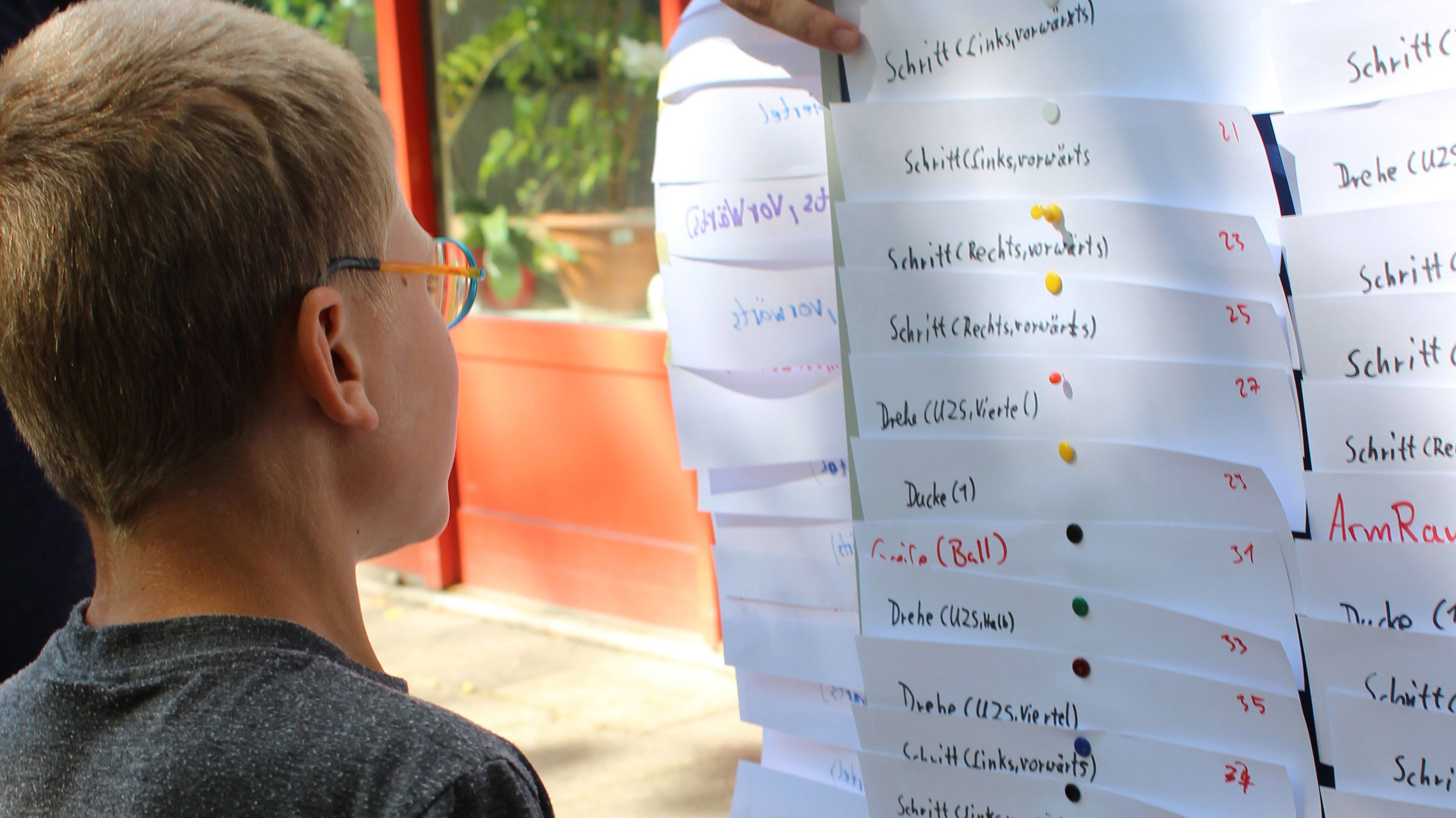 einem Jungen wird eine Übung zum Programmieren erklärt
