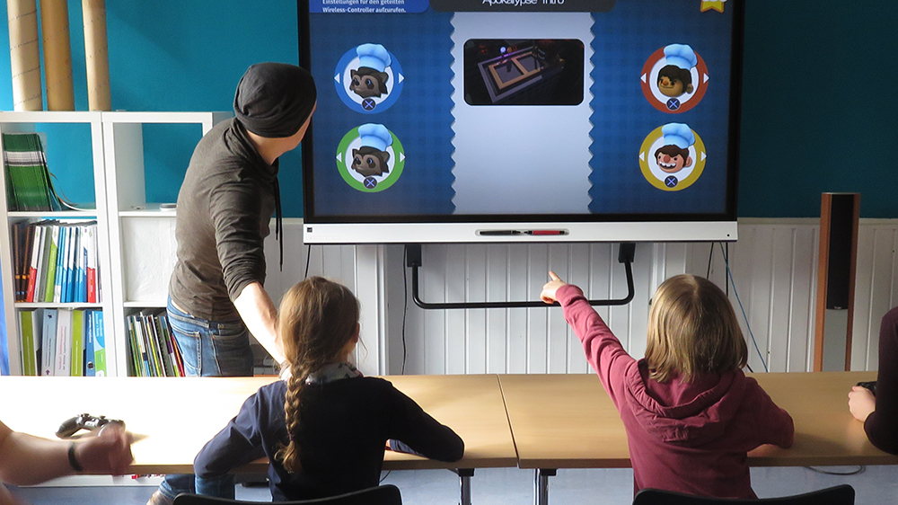 Kinder spielen zusammen am Smartboard