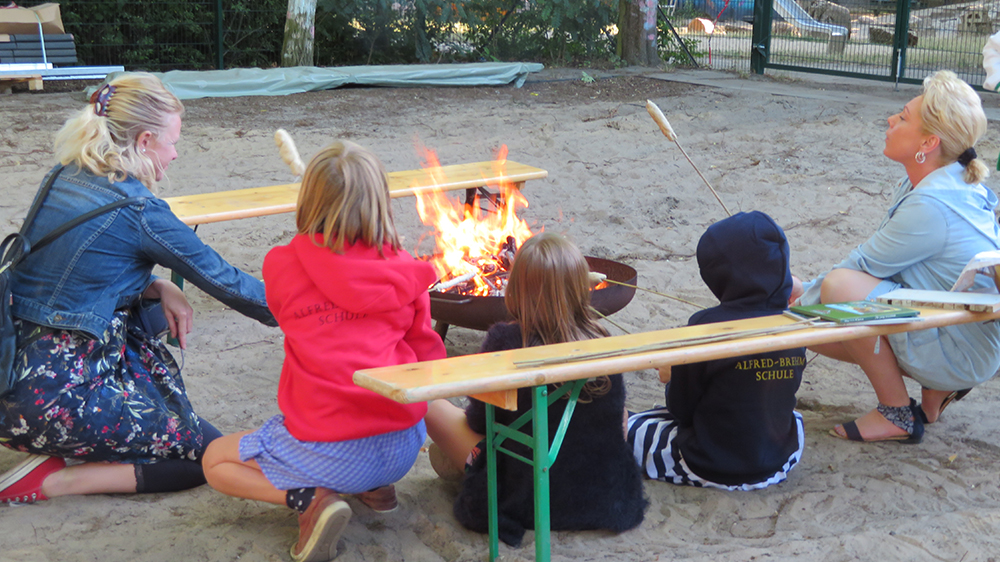 Menschen vor einer Feuerschale